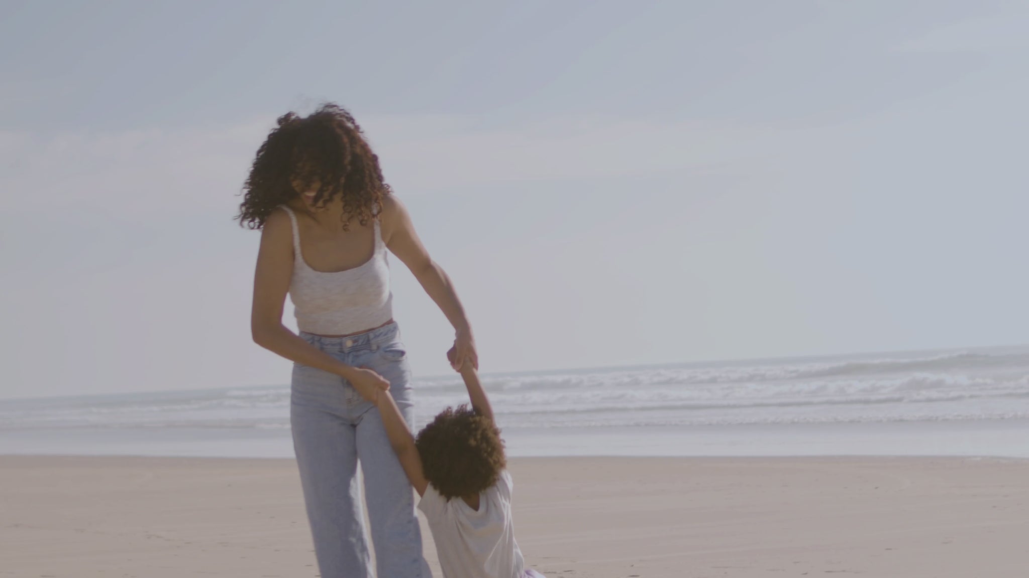 Woman playing with her kids at the beach